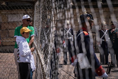Un padre y su hijo miran a través de las rejas a los integrantes  de la Guardia Presidencial, en la Plaza de Bolívar.
