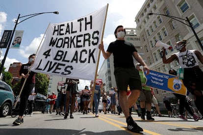 People march during the Health Care Justice demonstration rally in Chicago, Saturday, June 27, 2020.
