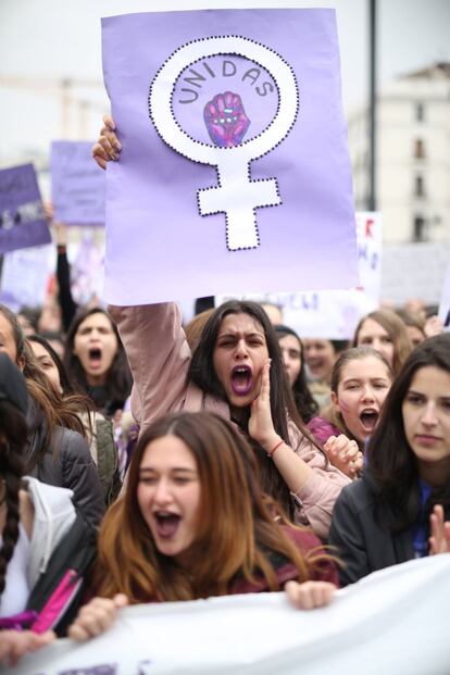 A student holds up a sign that reads “united” at the protest at Puerta del Sol in Madrid.