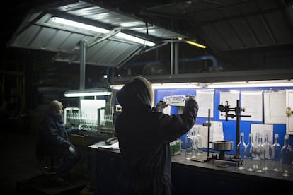 In this Wednesday, Jan. 27, 2016 photo, an employee checks the quality of glass bottles on the production line at Phoenicia Glass Works Ltd. factory in the southern Israeli town of Yeruham. Phoenicia Glass Works, Israelx92s only glass container factory, produces one million containers a day. Some 300,000 bottles a day come out with defects, and the factory grinds them into shards and piles them in a desert lot to be melted into new bottles. The factory is in the middle of the desert, and works round the clock, every day of the year. (AP Photo/Oded Balilty)