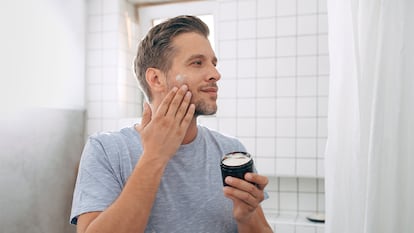 A man putting on cream.