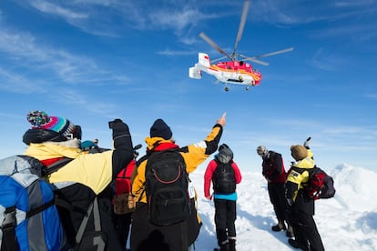Miembros de la tripulación del barco ruso MV Akademik Shokalskiy atrapado en la Antártida esperan el aterrizaje del helicóptero de rescate