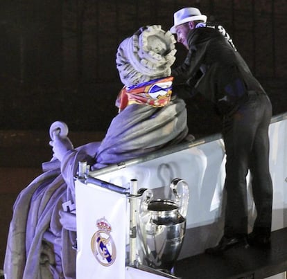 El segundo capit&aacute;n del Real Madrid Sergio Ramos pone la bufanda madridista a la estatua de la Cibeles.