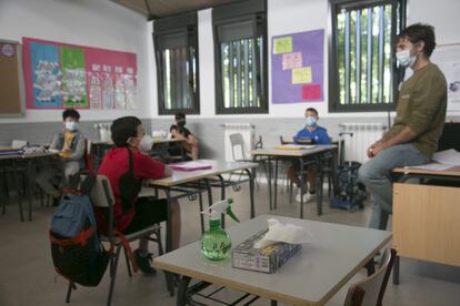 Varios alumnos escuchan al profesor, en el primer día de la vuelta voluntaria a las aulas, en el colegio público San Sebastián, en El Boalo (Comunidad de Madrid).