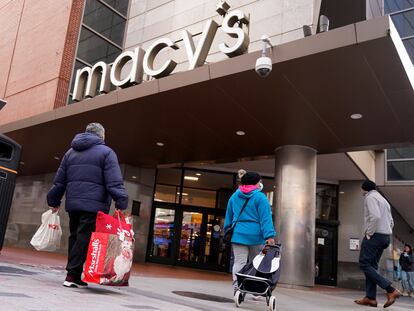 Shoppers walk to the Macy's store in the Downtown Crossing district, Wednesday, Nov. 17, 2021, in Boston.