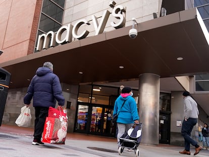 Shoppers walk to the Macy's store in the Downtown Crossing district, Wednesday, Nov. 17, 2021, in Boston.