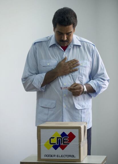 El presidente interino y candidato presidencial Nicolas Maduro asume una actitud de oración antes de emitir su voto en Caracas.