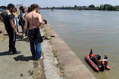 Familiares observan a los miembros del Cuerpo de Bomberos durante su intervención en el río Loira, donde Steve Canico, de 24 años, desapareció después de caer en el río, en Nantes, al oeste de Francia. 14 personas fueron rescatado después de caer en el río Loira durante la 'Fiesta de la Música' tras una operación de la policía francesa el 21 de junio de 2019.