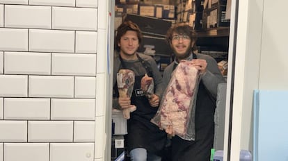 Carlos Schvartzman (izquierda) con un trozo de costillar argentino en la cámara frigorífica de la carnicería Bistec en Pozuelo de Alarcón.