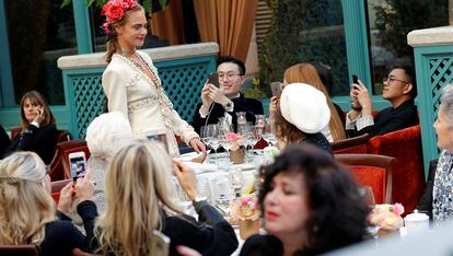 Model Cara Delevingne presents a creation with a Paris Cosmopolite theme by designer Karl Lagerfeld during the Metiers D&#8217;Art Show for Chanel fashion house in Paris