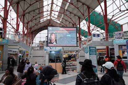 A digital billboard displays missing person announcements at the La Paz Bus Terminal.

