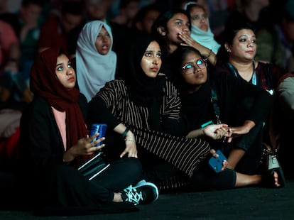 A group of women watch a World Cup game on a giant screen in the Fan Zone of Doha, Qatar, circa 2022.