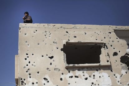 Un ni&ntilde;o observa desde una casa destruida cerca al cruce fronterizo con Egipto, Rafah, en la Franja de Gaza.