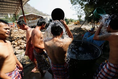 Patients take a cool shower after having a steam bath at the rehabilitation area at Wat Thamkrabok monastery in Saraburi province, Thailand, February 8, 2017. REUTERS/Jorge Silva SEARCH "TEMPLE SILVA" FOR THIS STORY. SEARCH "WIDER IMAGE" FOR ALL STORIES.