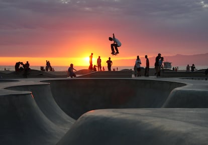 Skaters do tricks at the Venice Beach skatepark.