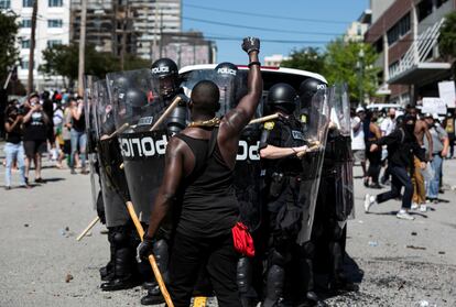 Un manifestante levanta el brazo frente a policías en un mitin contra la muerte bajo custodia policial de George Floyd, en Columbia, Carolina del Sur (EE UU), el 30 de mayo de 2020.