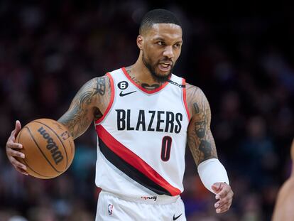 Portland Trail Blazers guard Damian Lillard brings the ball up against the New York Knicks during the second half of an NBA basketball game in Portland, Ore., Tuesday, March 14, 2023.