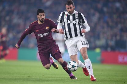 El defensa del Juventus Andrea Barzagli (derecha) y Luis Suárez.luchan por la pelota.