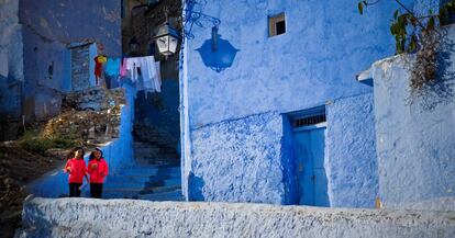 Dos j&oacute;venes pasean por una calle de Chefchaouen. 