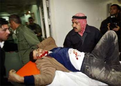 Varios palestinos ayudan a introducir a un joven herido en el hospital Shifa en Gaza.