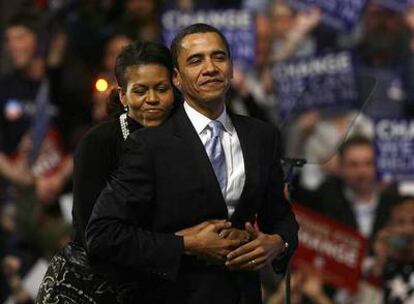 Michelle Obama abraza a su esposo Barack durante el mitin de la noche electoral en Nashua.