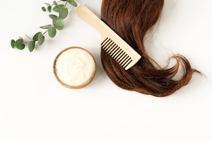 female hair, hair mask and bamboo comb on white background top view, flat lay. copy space. Self care concept.