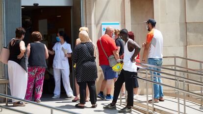 People waiting outside Prat de la Riba primary healthcare center in Lleida on Tuesday.