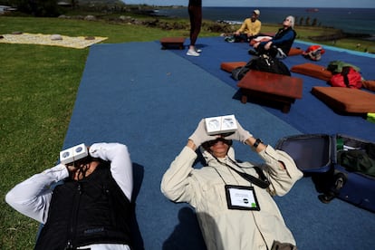 People observe the solar eclipse from Tahai archaeological monument area in the Rapa Nui national park managed by the Mau Henua native community at Easter Island, Chile October 2, 2024. REUTERS/Ivan Alvarado