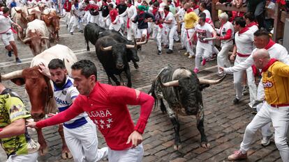 Varios mozos corren delante de la manada de Victoriano del Río en el tercer encierro de los Sanfermines este martes, en Pamplona.