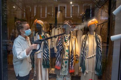Disinfecting a display window at a fashion boutique in San Sebastián.
