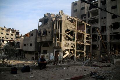 A Palestinian citizen sits outside what remains of his house after a bombing in northern Gaza.