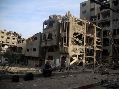 A Palestinian citizen sits outside what remains of his house after a bombing in northern Gaza.