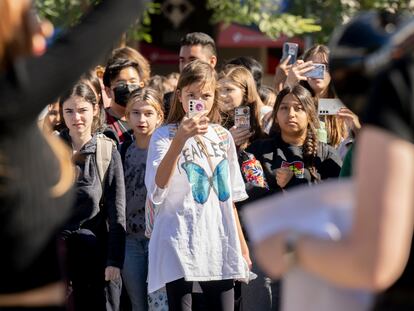 Young students film during a protest at a school in Santa Ana, California, November 2022.
