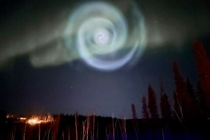 A light baby blue spiral resembling a galaxy appears amid the aurora for a few minutes in the Alaska skies near Fairbanks