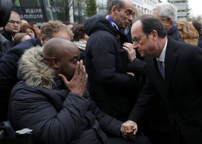 El presidente francés, François Hollande, saluda a una víctima tras descubrir una placa conmemorativa en el Estadio de Francia.