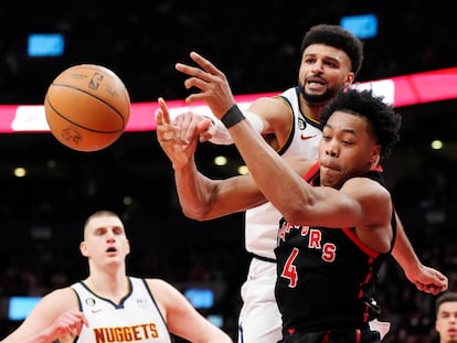 Denver Nuggets guard Jamal Murray and Toronto Raptors forward Scottie Barnes (4) vie for the ball during the first half of an NBA basketball game Tuesday, March 14, 2023, in Toronto.