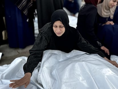 Una mujer llora cerca de varios cadáveres de palestinos muertos en la morgue del hospital Europa de Jan Yunis, este martes.