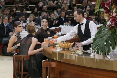 Cara Delevingne y Kendall Jenner (de frente), sentadas en el 'bistró' organizado por Chanel.