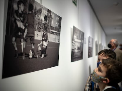 Dos niños contemplan una de las imágenes de la exposición 'Una cancha llamada Madrid'.