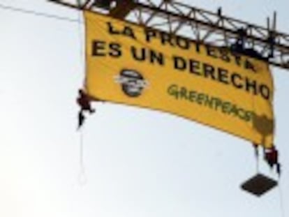 Environmental group unfurls banner against controversial law. The organization says the legislation penalizes peaceful demonstrations