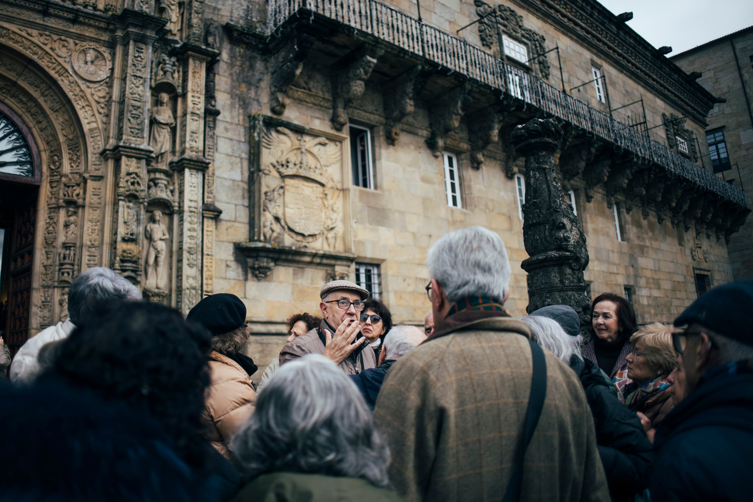 Benxamín Vázquez (en el centro, con visera) guía una visita sobre las gárgolas en Santiago.