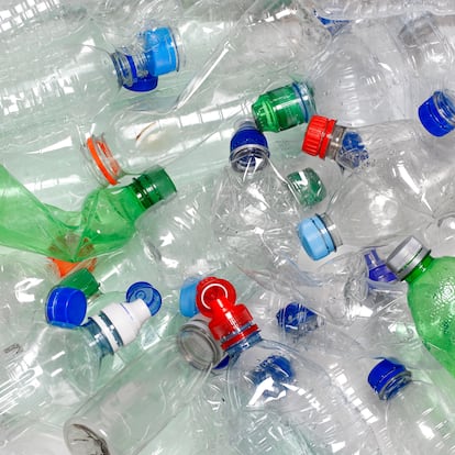 discarded used water bottles in recycling bin.  The lids can be recycled as well if reattached to the water bottle