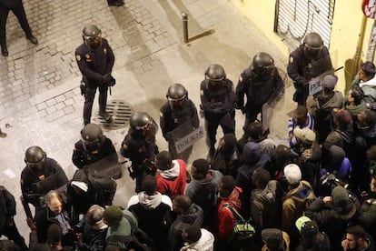Policías antidisturbios frente a manifestantes en la calle Mesón de Paredes, en Lavapiés.