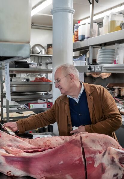 Trevor Gulliver examines a piece of meat that has just arrived at the restaurant.