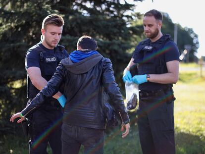 A suspected illegal migrant is searched after he was detained by German police during their patrol along the German-Polish border to prevent illegal migration, in Forst, Germany, September 20, 2023