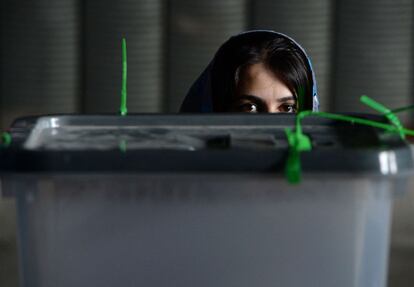 Una trabajadora de la comisión electoral afgana espera la apertura de los sellos de una urna llena de papeletas de voto para una auditoría en un centro de recuento en Kabul. 17 de julio de 2014.