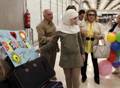 Sara, la niña que permaneció tres años retenida por su padre en Irak, es recibida por familiares a su llegada al aeropuerto de Barajas.