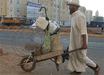 Un hombre empuja una carretilla en Sidi Mumen,  de donde procedían los terroristas.