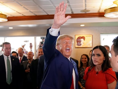 Former President Donald Trump waves to supporters at Versailles restaurant on Tuesday, June 13, 2023, in Miami.