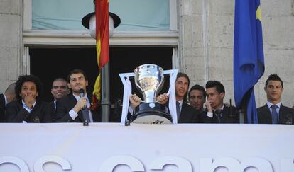 La plantilla del Real Madrid ofrece el trofeo desde el balcón del ayuntamiento de Madrid, en la Real Casa de Correos